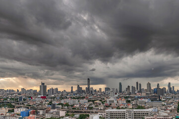 Dramatic storm clouds with rain cover the city.