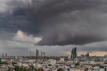 Dramatic storm clouds with rain cover the city.