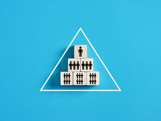 Pyramid of wooden cubes symbolizing the hierarchy of society or company organization model.
