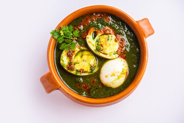 Spinach egg curry is an Indian non vegetarian dish made using palak gravy with eggs