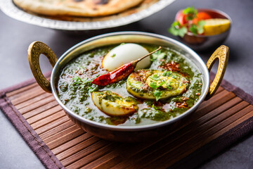 Spinach egg curry is an Indian non vegetarian dish made using palak gravy with eggs