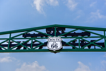 Route 66 symbol on iron bridge with a blue sky