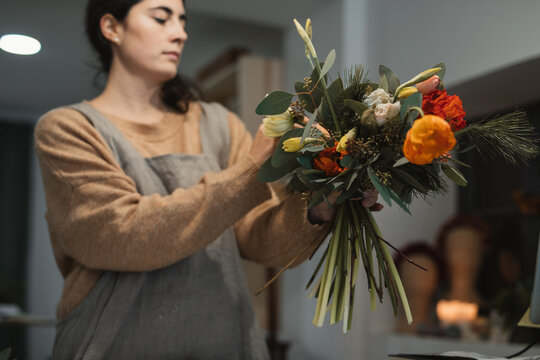 Florist making amazing decorative bouquet with dry flowers in workplace