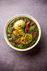 Spinach egg curry is an Indian non vegetarian dish made using palak gravy with eggs