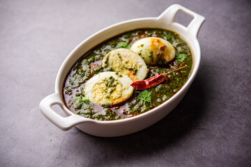 Spinach egg curry is an Indian non vegetarian dish made using palak gravy with eggs