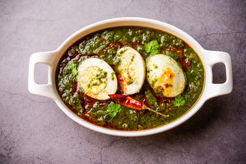 Spinach egg curry is an Indian non vegetarian dish made using palak gravy with eggs
