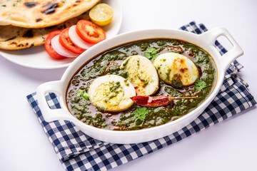 Spinach egg curry is an Indian non vegetarian dish made using palak gravy with eggs