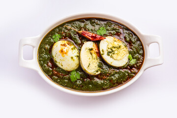 Spinach egg curry is an Indian non vegetarian dish made using palak gravy with eggs