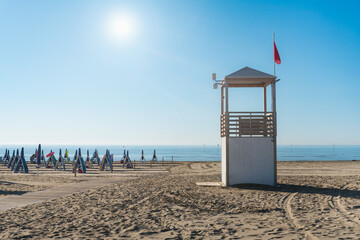 Beach at the Adriatic sea coastline in Italy, Europe during summer. Traditional hut for the beach...