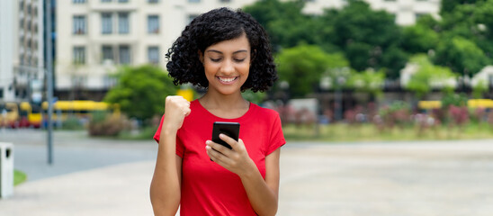 Arabic young adult woman receiving message with good news at mobile phone