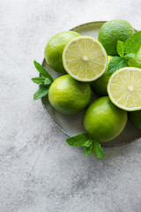 Green  Limes with fresh mint leaves on  plate