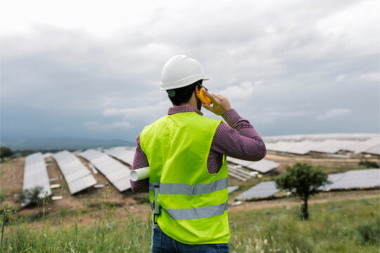 Anonymous foreman talking on radio near solar power plant