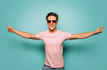 Content masculine model in sunglasses on blue background