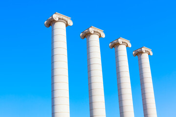 Greek Ionic Columns Against Blue Sky . Ancient architecture style 