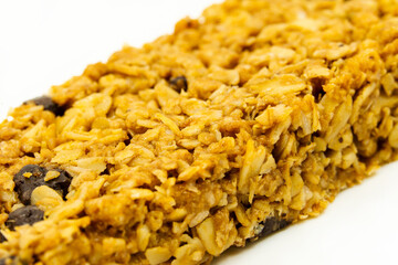 Whole grain bitter chocolate diet bar on a white background, macro shot