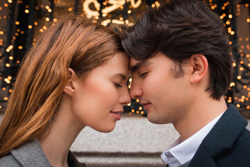 Young couple in love enjoying romantic moment on street