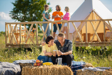 Posing in front of the camera pretty couple enjoy the moment together in the middle of campsite...