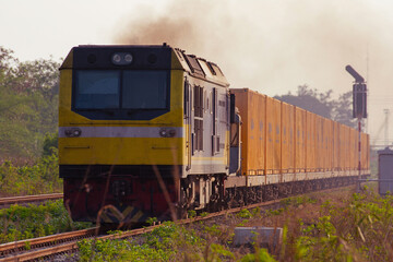 Fototapeta premium Container-freight train by diesel locomotive on the railway in Thailand
