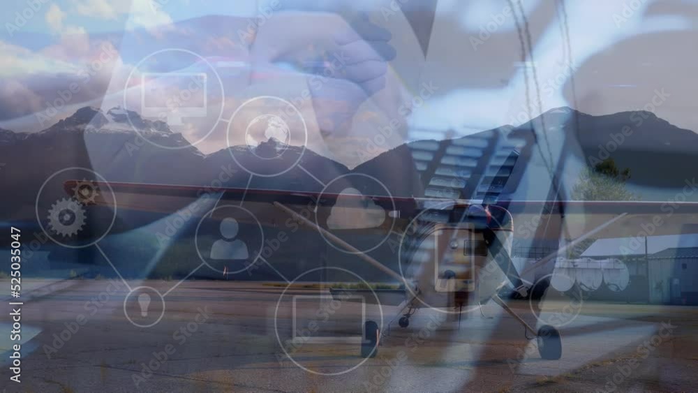 Poster animation of tech icons and plane over hands of caucasian man typing on keyboard