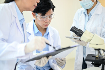 A team of Asian technician or scientist working together in the lab