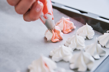 Process of making homemade meringue, woman cooking sweet cream for dessert on baking sheet