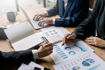 Group of business people meeting to plan marketing activities view graph, chart, financial account, balance sheets of various companies to develop and expand the business further.