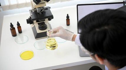 A specialist Asian male scientist or medical researcher in his laboratory.
