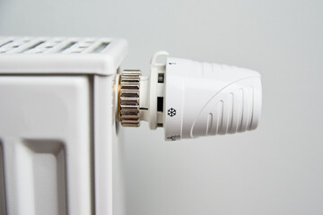 Heating radiator with temperature control knob, Energy crisis concept, Rising costs in private households for gas bill due to inflation and war