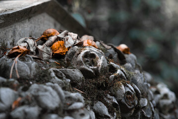 Sculpture of roses from stone on a tomb in the southwest churchyard Stahnsdorf, a famous woodland-...