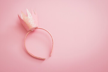 Pink princess crown headband for girls on pink background. Festive girlie feminine birthday party or performance. Flat lay minimalistic with copy space © avelina_boyko