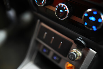 Obraz premium The process of choosing climate control in the car. Various controls in auto switches. Modern car interior