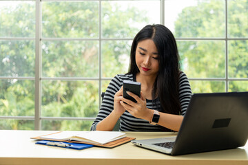 Asian woman hands using stylus pen writing on personnal pda to check information in office room...