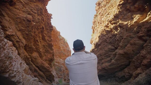 Man taking photos of a canyon 