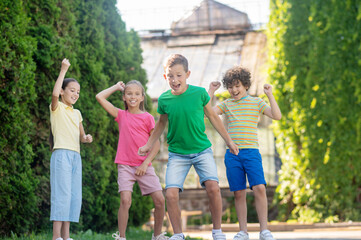 Boy with friends actively playing in park