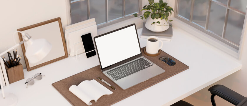 Minimal working space with laptop mockup, book, stationery and decor on tabletop. above view