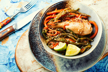 Fried chicken legs and a vegetable side dish
