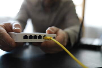 Modern dual band wireless router. Man working in the background. Fast and wireless internet concept.