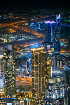Aerial view of beautiful evening night illuminations scenic view of skyscraper and towers in Dubai. Street night traffic in Dudai skyline. Urban background of Dubai, UAE, United Arab Emirates © Grigory Bruev