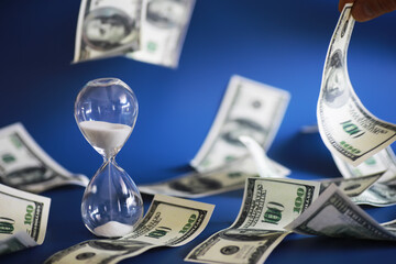 Green dollar bills on a blue background. 100 dollar bills close up. The concept of wealth and...