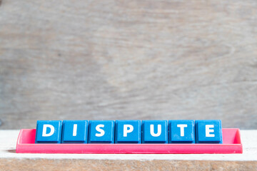 Tile alphabet letter with word dispute in red color rack on wood background