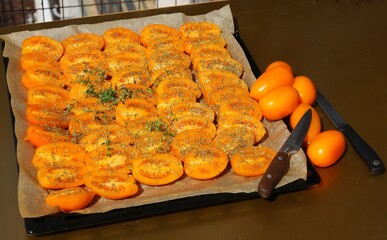 cut tomatoes as halves drying in hot sunshine