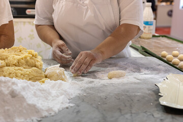 Working with Hands of Uncooked Dough with Flour and Eggs for Making Round Cakes