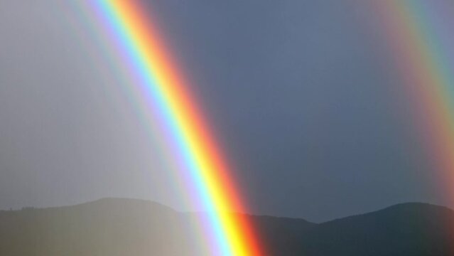 Two Rainbow over Sky and Mountain in Lugano, Ticino in Switzerland.