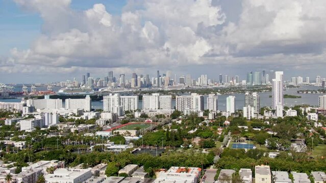 Dolly zooming in Miami city skyline, aerial distance view