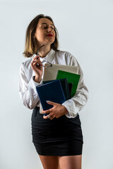 beautiful young business lady standing with documents isolated on white background.