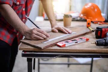 Closeup of unrecognizable young woman art and craft project sitting at wooden table in workshop diy