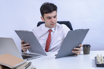 Young broker working with laptop,