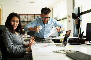 Colleagues arguing in office. Angry businessman yelling at his collegue