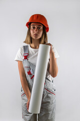 woman in construction uniform helmet on her head posing isolated on white background.