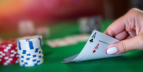 beautiful young woman with cards in her hands makes a card move in poker.